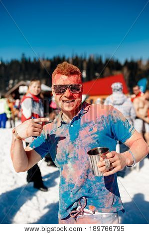 Sheregesh, Kemerovo region, Russia - April 16, 2016: Grelka Fest is a sports and entertainment activity for ski and snowboard riders in bikini. man in paints holi.