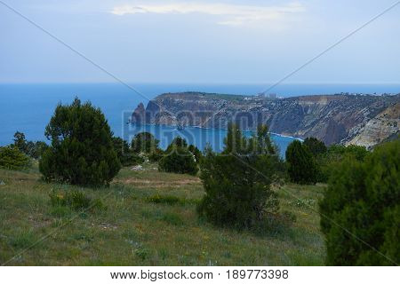 Hiking place for relax on the seaside in Crimea near scale Fiolent. Fishing concept with sea rocks and blue sky background in summer evening.
