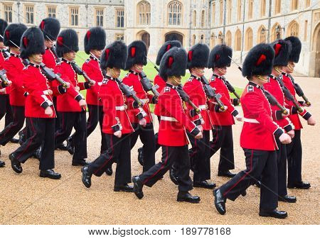 WINDSOR - APRIL 16: Unidentified men members of the royal guard during change ceremony on April 16, 2016 in Windsor, United Kingdom.