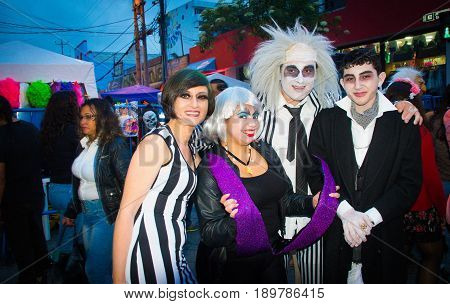 Quito, Ecuador - December 31, 2016: An unidentified group of people dreessed with differents customs celebrating new years gathering in city streets.