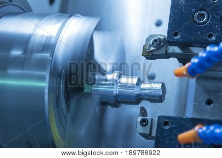 The CNC lathe machine or Turning machine cutting the metal rod with the lathe tool .The hi-technology machining concept.