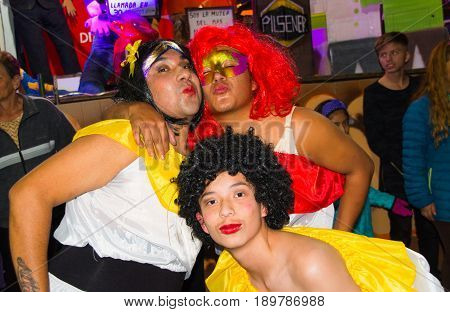 Quito, Ecuador - December 31, 2016: An unidentified group of guys dreessed with women's clothes celebrating new years gathering in city streets.