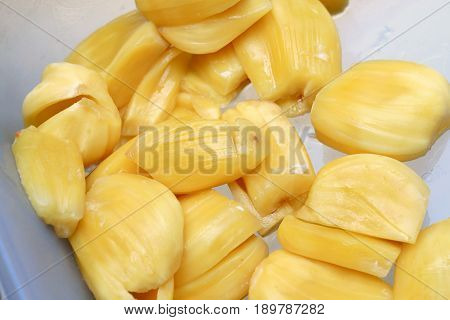 Piece Of Sweet Yellow Jackfruit Tropical Fruit In Pastic Blow On Wooden Background.