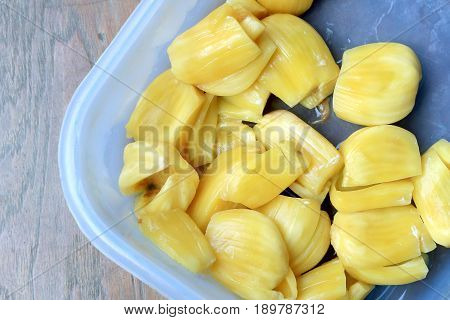 Piece Of Sweet Yellow Jackfruit Tropical Fruit In Pastic Blow On Wooden Background.
