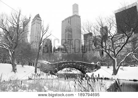 Gapstow bridge with snow at Central Park and buildings of Manhattan in black and white style