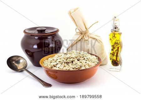 The Composition Of The Oatsmeal Groats In A Clay Pial Next To A Clay Pot And A Copper Spoon,