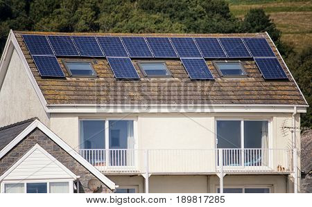 Collecting renewable green energy from the sun solar panels on a roof