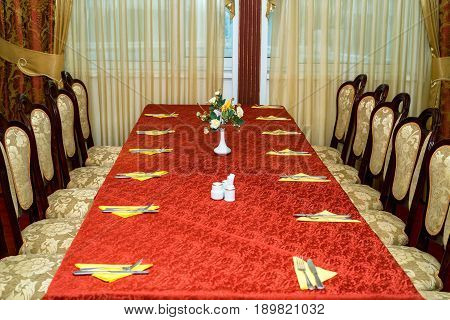 Big table at retaurant served for upcoming banquet