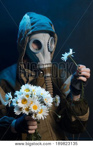 the photo of girl in gas mask on grey background c daisies