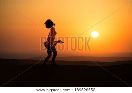 Young woman dancer on outdoor unrise background.