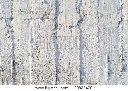 Texture of wooden formwork stamped on a raw concrete wall as background. Vertical strips from formwork