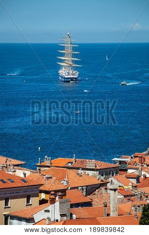 The world's largest sailing ship with five masts anchored in the open sea near old city Piran Slovenia.