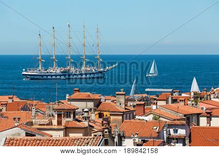 The world's largest sailing ship with five masts anchored in the open sea near old city Piran Slovenia.