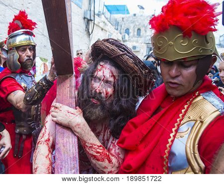 JERUSALEM - APRIL 14 : Christian pilgrims re-enact the crucifixtion of Jesus along the Via Dolorosa in Jerusalem during Good friday on April 14 2017