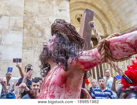 JERUSALEM - APRIL 14 : Christian pilgrim re-enact the crucifixtion of Jesus along the Via Dolorosa in Jerusalem during Good friday on April 14 2017