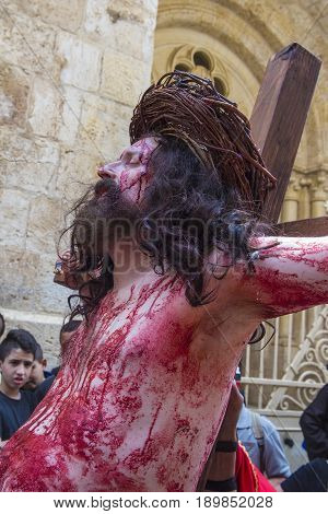JERUSALEM - APRIL 14 : Christian pilgrim re-enact the crucifixtion of Jesus along the Via Dolorosa in Jerusalem during Good friday on April 14 2017
