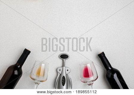 Two wine glasses with red and white wine, bottles of red wine and white wine, corkscrew on white background. Horizontal view from the top. Mock-up. Copy space. Flat lay