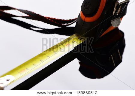 Measuring Tape With Self Retracting Mechanism On Grey Surface