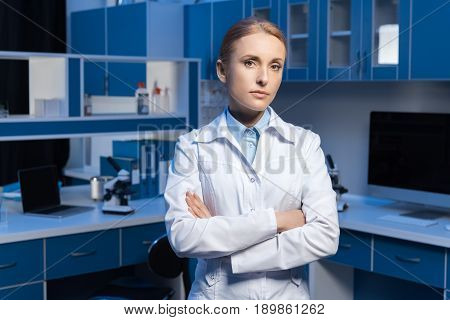 Confident Scientist In Lab Coat Looking At Camera With Arms Crossed
