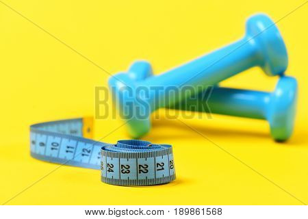Barbell With Measuring Tape In Selective Focus On Yellow