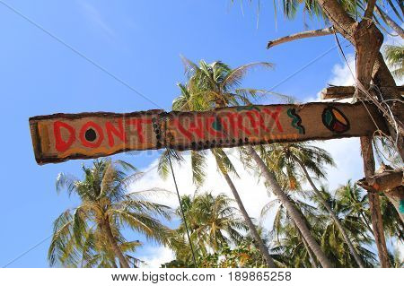 Travel To Island Koh Lanta, Thailand. An Inscription “don’t Worry” On The Wooden Abandoned Hut.