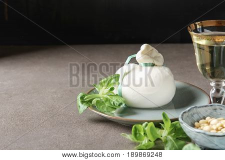 Italian Fresh Burrata Cheese In A Ceramic Mash With Green Salad