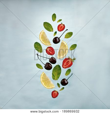 Summer Food and Drink - Fruit Lemonade Ingredient Pattern made of Strawberries, Cherries, Mint and Lemon. Splash Shape with Flying Drink Ingredient. Summer Fruit Drink Ingredient Concept. Flat Lay