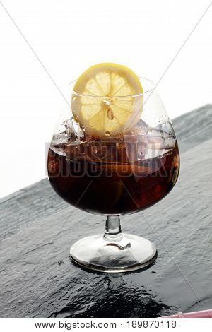 Softdrink With Ice Cubes, Lemon And Straw In Glass