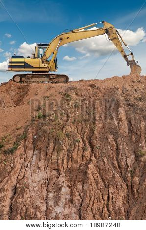 Radlader Bagger in offenen Sand mine über landschaftlich blauer Himmel