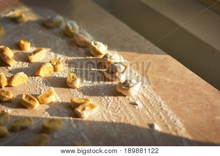 Process of making dumplings, raw ravioli in flour in details