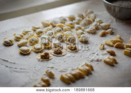 Process of making dumplings, raw ravioli in flour in details