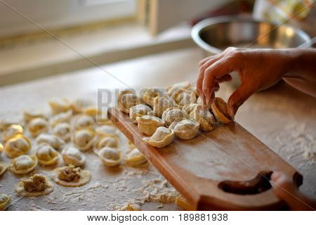 Process of making dumplings, raw ravioli in flour in details