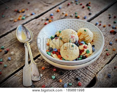 homemade ice cream peach light bowl with coloured chocolate - spoons on the right