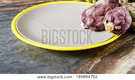 Baby Ripping Organic Artichokes With Lemon. Food For A Vegan And