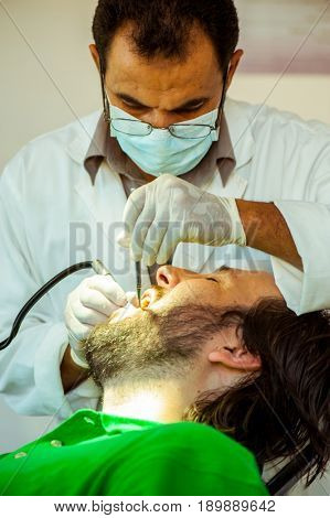 Man at the dentist clinic fixing his teeth