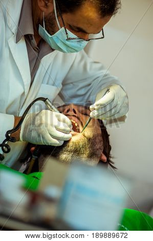 Man at the dentist clinic fixing his teeth