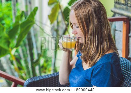 Young Beautiful Redhead Woman Sitting In A Cafe Drinking A Delicious Morning Ginger Tea In A Cafe