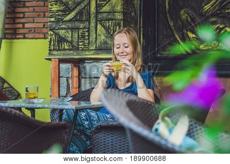 Young Beautiful Redhead Woman Sitting In A Cafe Drinking A Delicious Morning Ginger Tea In A Cafe
