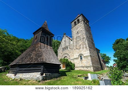 The Church of the Assumption of the Virgin Mary - kostel Nanebevzeti Panny Marie - and a wooden belfry in the village of Vysker in the Bohemian Paradise.