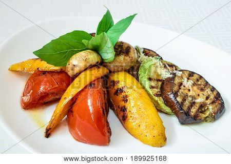 Elicious Grilled Vegetables, Courgettes, Peppers, Mushrooms And Herbs, On A White Plate. Horizontal