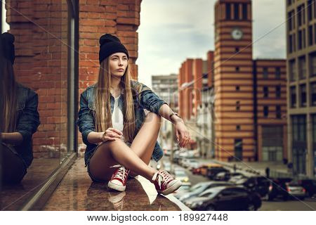 Outdoor Lifestyle Portrait Of Pretty Young Sitting Girl, Wearing In Hipster Swag Grunge Style Urban