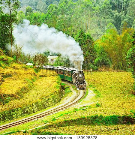 Steam narrow-gauge train moves from Yuejin to Bagou through the chinese countryside. Jiayang Mining Region. Sichuan province. China.