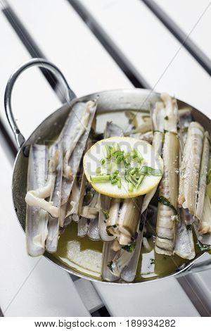 portuguese fresh razor shell seafood steamed in garlic herb white wine sauce
