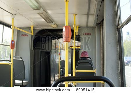 The interior of the old tram with multiple passengers.