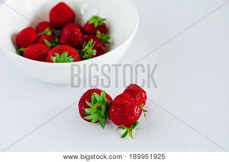 Fresh raw healthy diet strawberries fruit in plateisolated on whiteview aboveflatlay close-upcopyspace for textframe