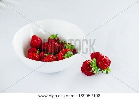 Fresh raw healthy diet strawberries fruit in plateisolated on whiteview aboveflatlay close-upcopyspace for textframe