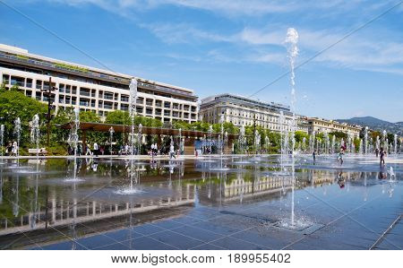NICE, FRANCE - JUNE 4, 2017: A view of the reflecting pool of the Promenade du Paillon in Nice, France. This pool in the large public park has 128 water jets, that delight children