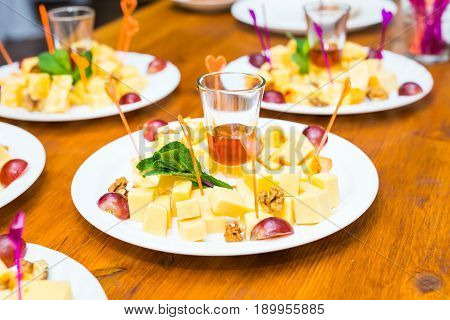 Cubes of yellow cheese on the plate