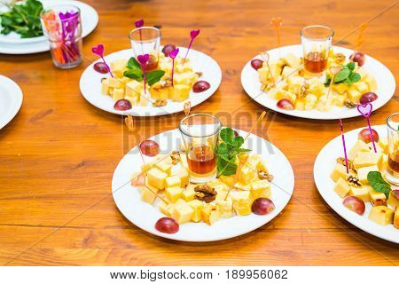 Cubes of yellow cheese on the plate