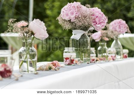 flowers settings decoration outdoor setup for a wedding with pink colored flower